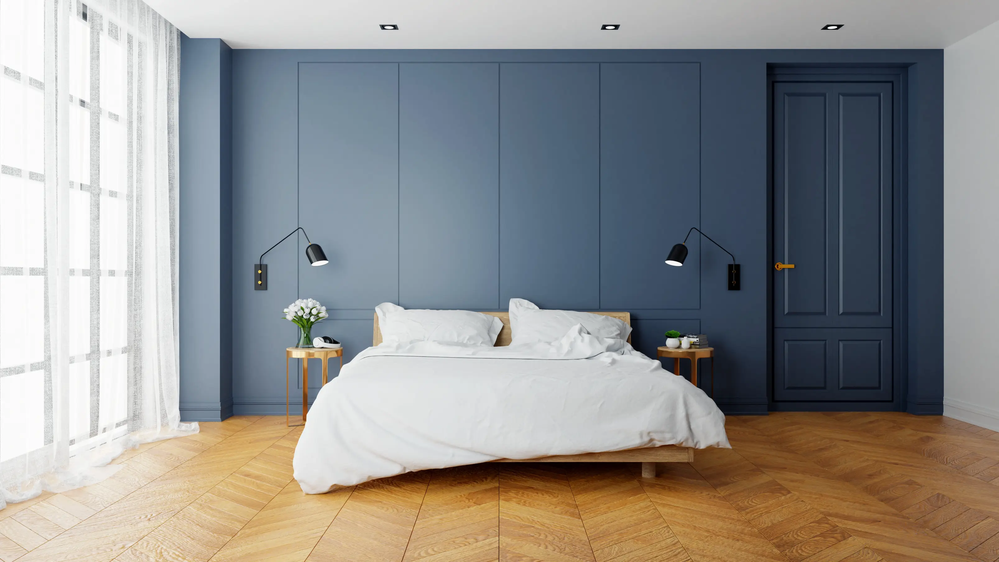 Sypialnia w kolorze niebieskim z niebieską ścianą, styl minimalistyczny. Element charakterystyczny: niebieska ściana