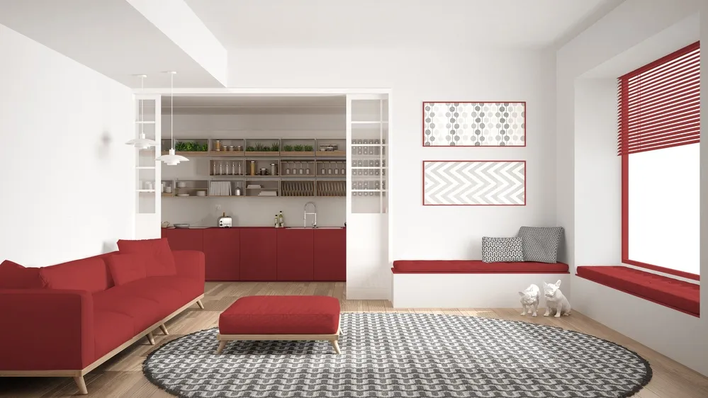 Kuchnia z salonem w stylu minimalistycznym w odcianiach czerwieni.